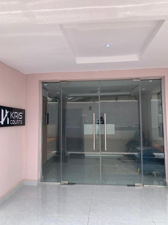 an empty room with a glass door in a building at Kris Courts in Ibadan