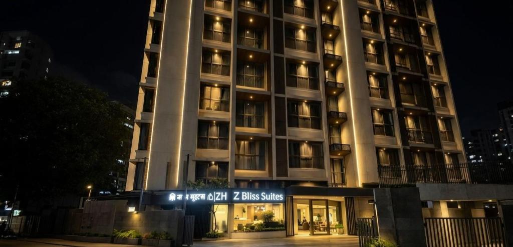 a tall building with a sign in front of it at Z Bliss Suites, BKC in Mumbai