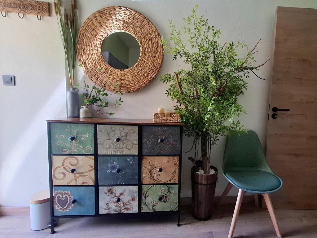 a green chair next to a dresser with a mirror at Beach fun in Costa da Caparica