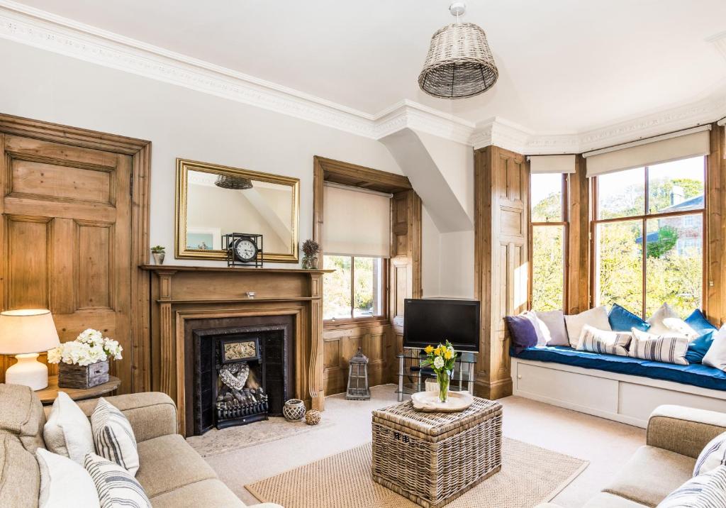 a living room with a couch and a fireplace at The Neuk in North Berwick