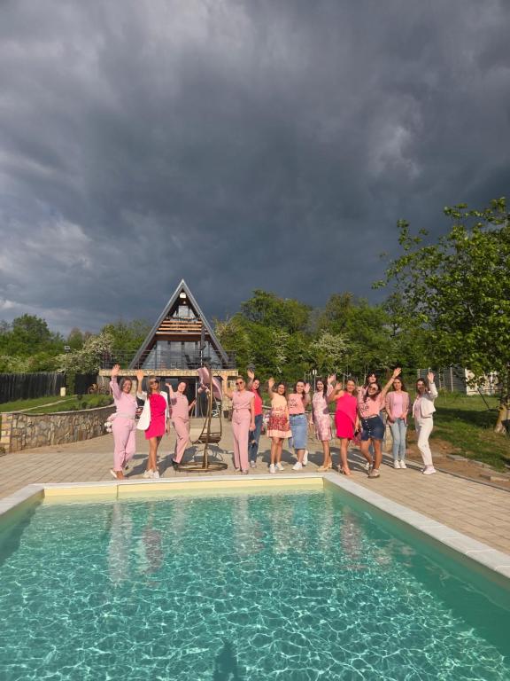 a group of people in pink dresses standing around a pool at Vezirove zore in Paraćin