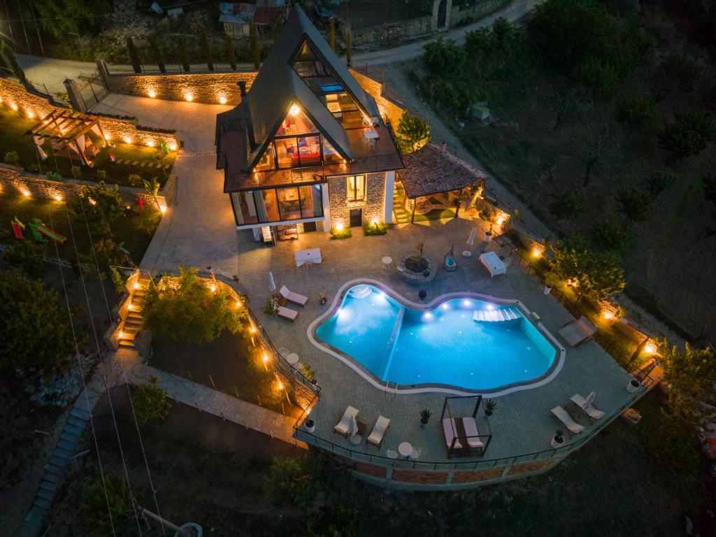 an aerial view of a house with a swimming pool at night at Sunrise House - Swimming Pool in Berat