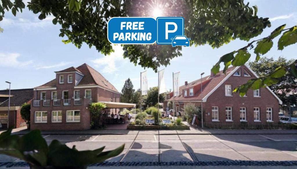 a sign that reads free parking in front of a building at Hotel Küstenklang - FREE Parking by ANS in Carolinensiel