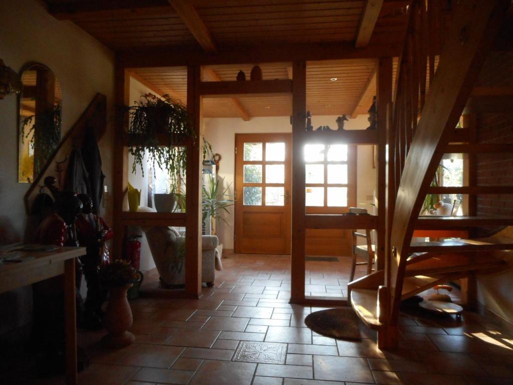 a living room with a staircase and a room with a door at Familienferienhof Sell´s Scheune in Sundhausen