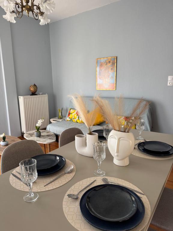 a dining room table with black plates on it at Metani Residence in Skala Sotiros