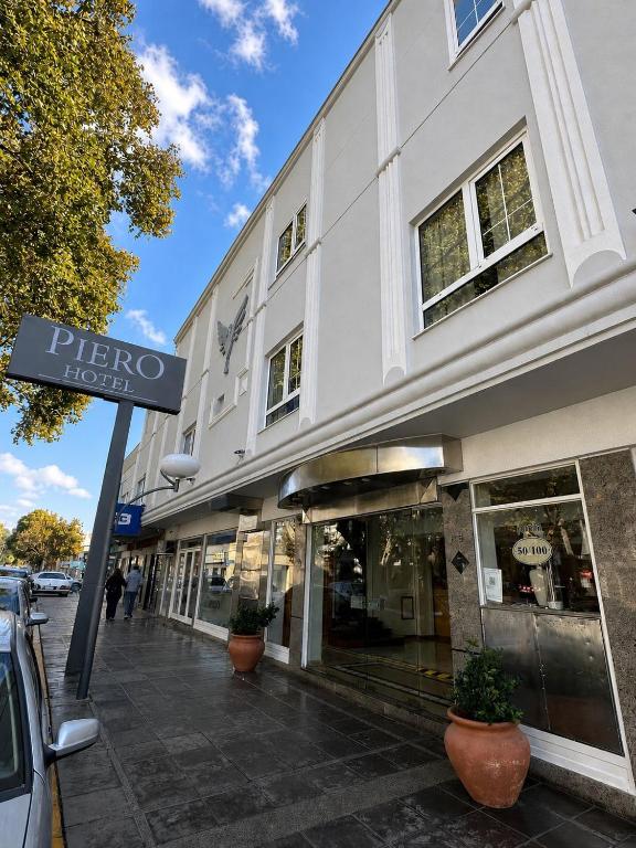 a white building with a sign in front of it at Hotel Piero in Villa Mercedes