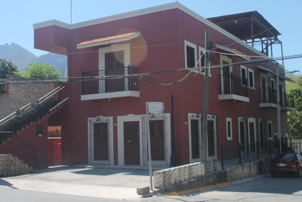 a red building with a stairway in front of it at Antigua Mariana Hotel Boutique in Cedro