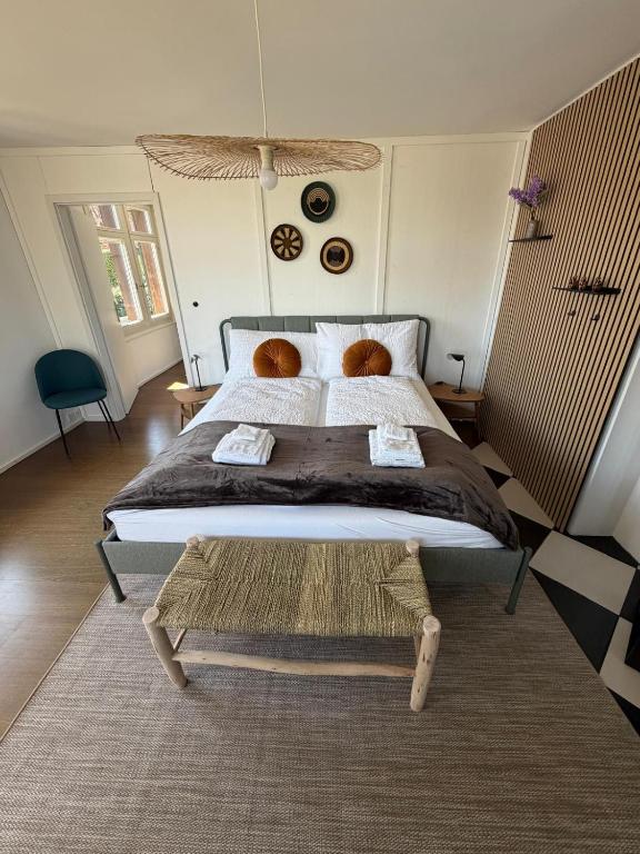 a bedroom with a large bed and a rug at LaVida Panorama Thunersee, Wellness Oasis, Mountains in Thun
