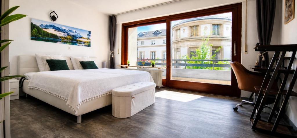 a bedroom with a bed and a large window at FeWo Prinzregent - große Zentrale Wohnung, ideal für Gruppen & Familien in Bad Kissingen