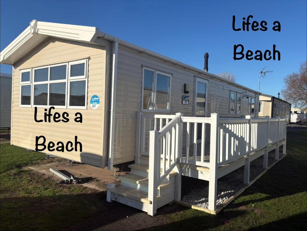 a tiny house with the words life a beach lives a beach at Lifes a Beach on Presthaven Sands in Prestatyn