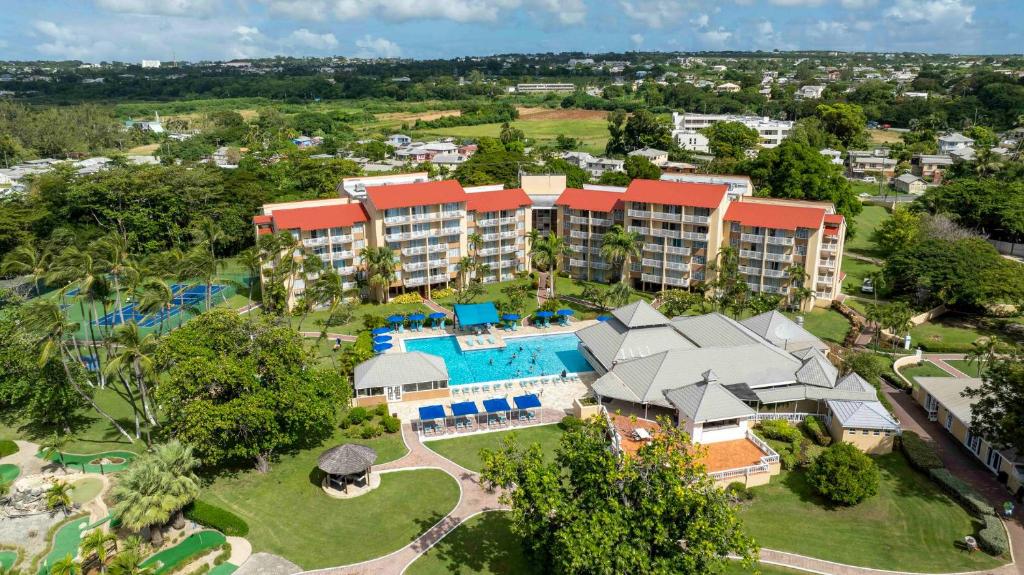 an aerial view of a resort with a pool and a resort at Divi Southwinds Beach Resort in Christ Church