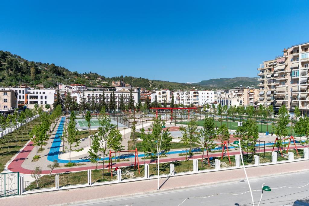 a city with a park with trees and buildings at Apartment Simon - Berat City Center in Berat