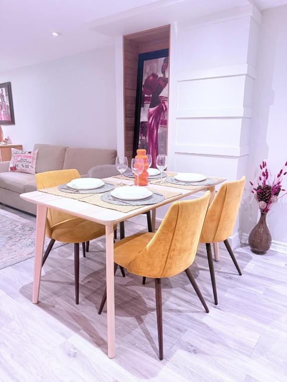a dining table and chairs in a living room at Large Private Suit With Free Parking in Mississauga