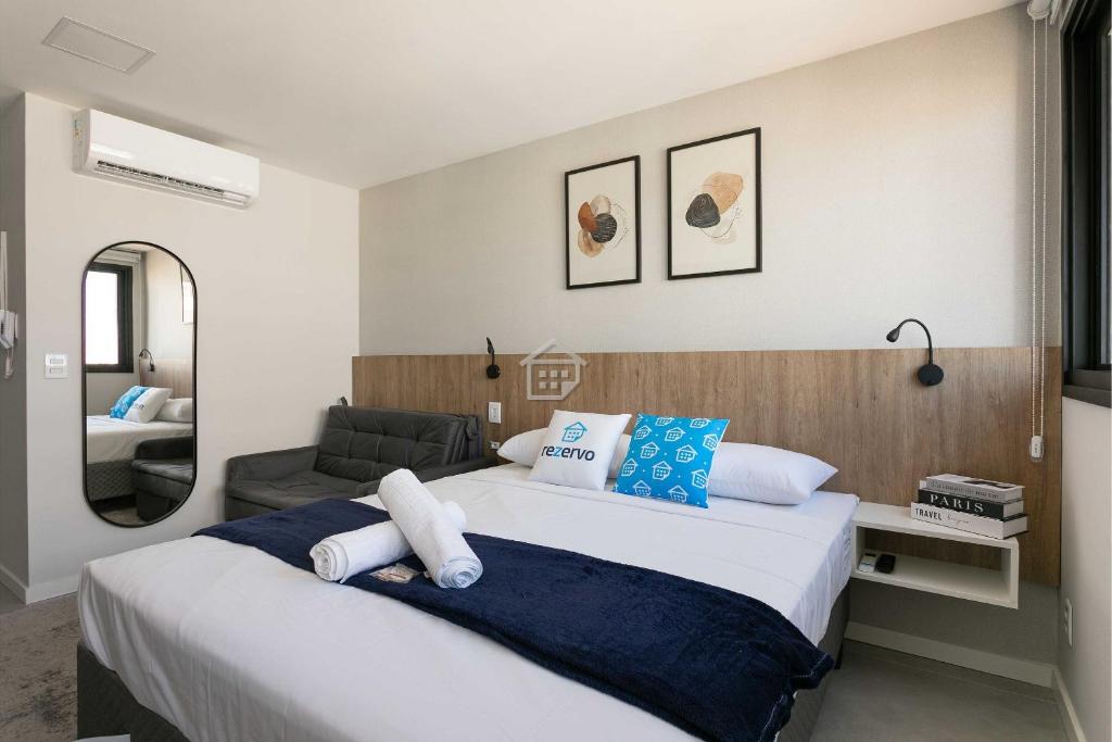 a bedroom with a large bed and a mirror at GO Rio Branco by Rezervo in Partenon