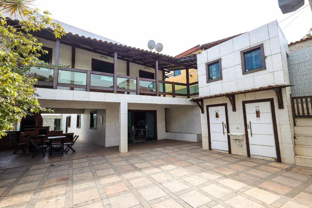 a large house with a patio and a balcony at House with Pool in BH for Groups and Families in Belo Horizonte