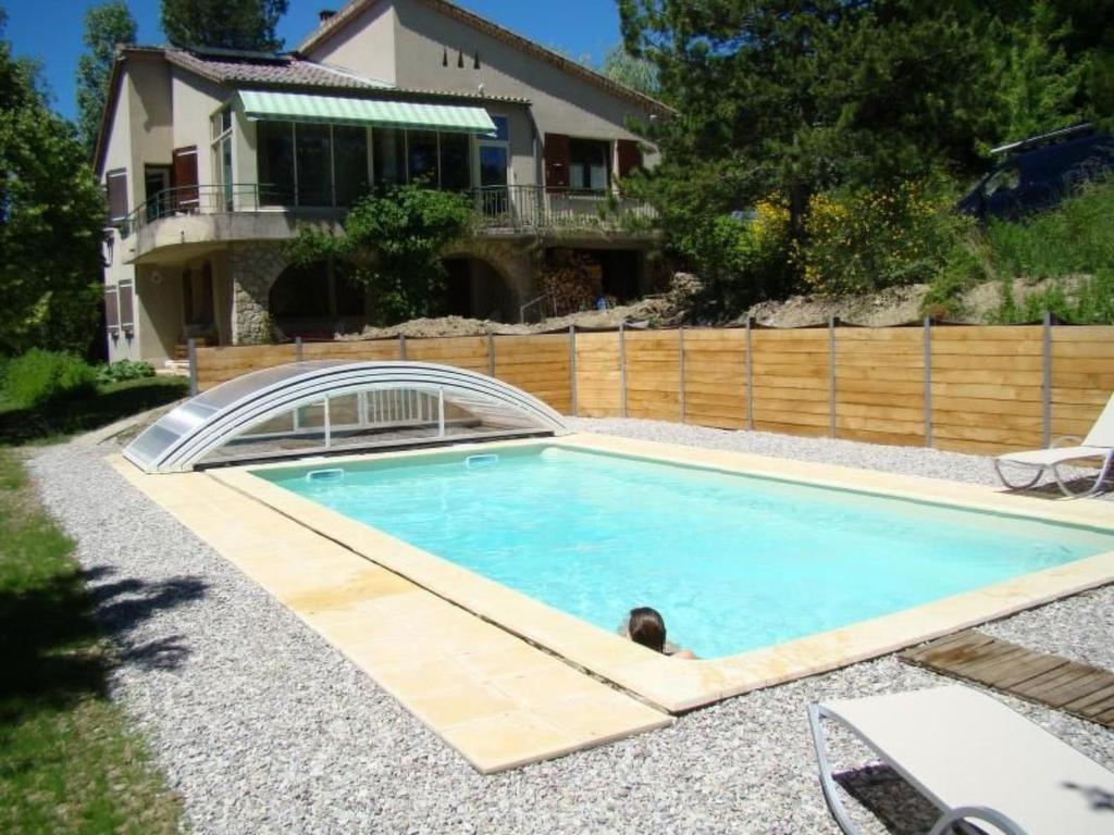 a swimming pool with a person in the middle at Apartment mit Gemeinschaftspool im Diois by Interhome in Die