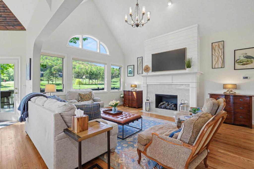 a living room with a couch and a fireplace at Chic Sky Valley Resort Home on Golf Course! in Sky Valley