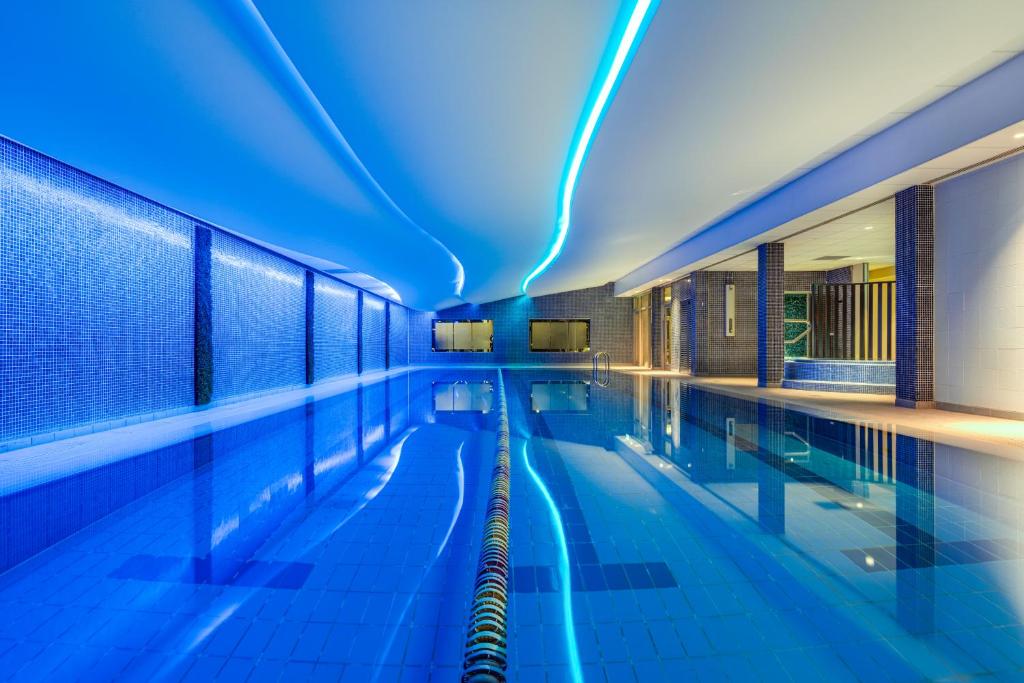 a swimming pool with blue lights in a building at The Spencer Hotel in Dublin