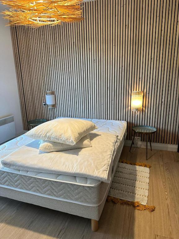 a bedroom with a bed and a wooden floor at chambre avec terrasse et coin repas in Ciboure