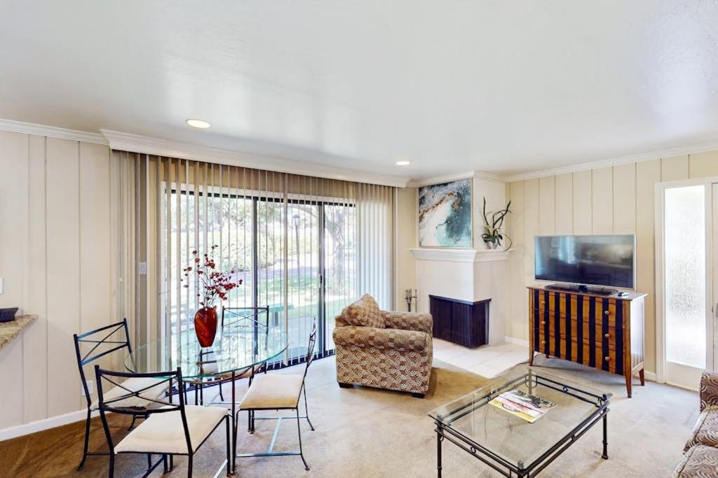 a living room with a glass table and a chair at Silverado Resort and Spa 374 & 375 in Napa