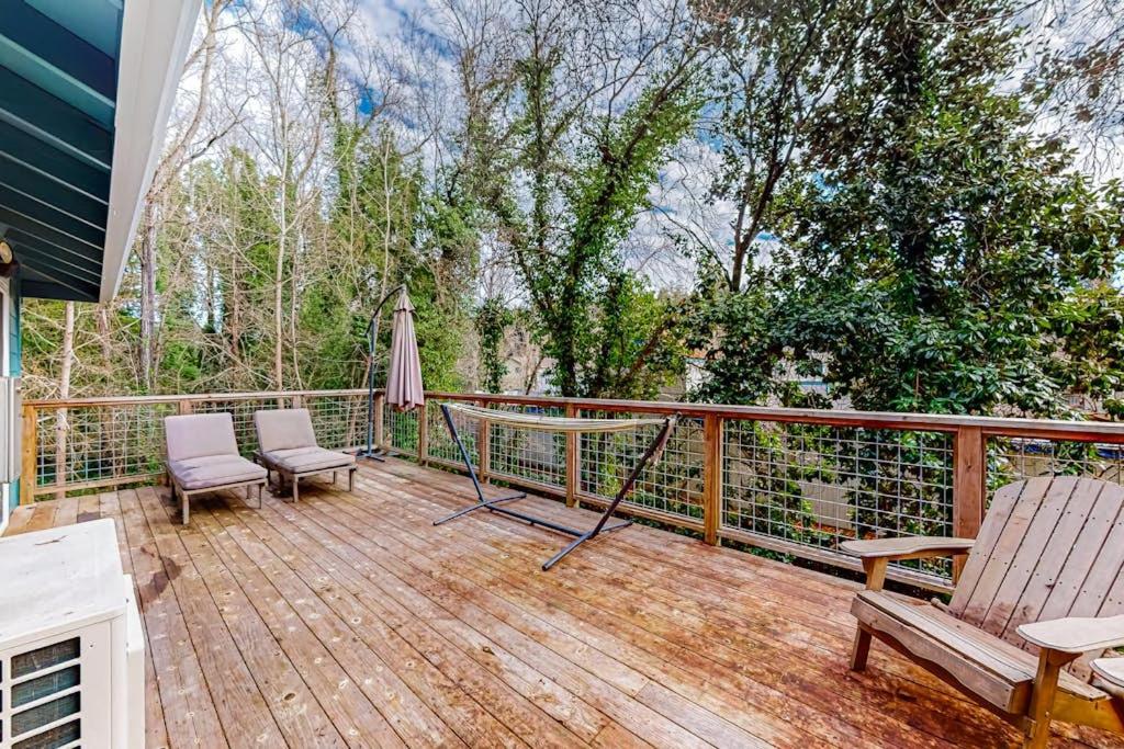 a wooden deck with two chairs and an umbrella at Old River Hideaway in Guerneville