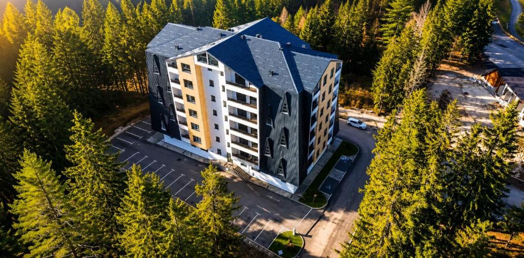 an aerial view of a building in a forest at Trebevic Skyline Apartman in Dovlići