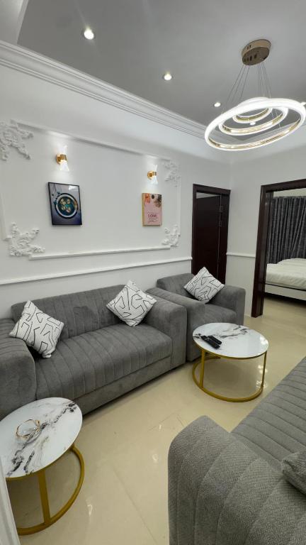 a living room with two couches and two tables at كورنيش عجمان in Ajman 
