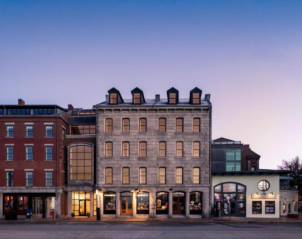 a large brick building with windows on a street at The Evalina Hotel in Portland