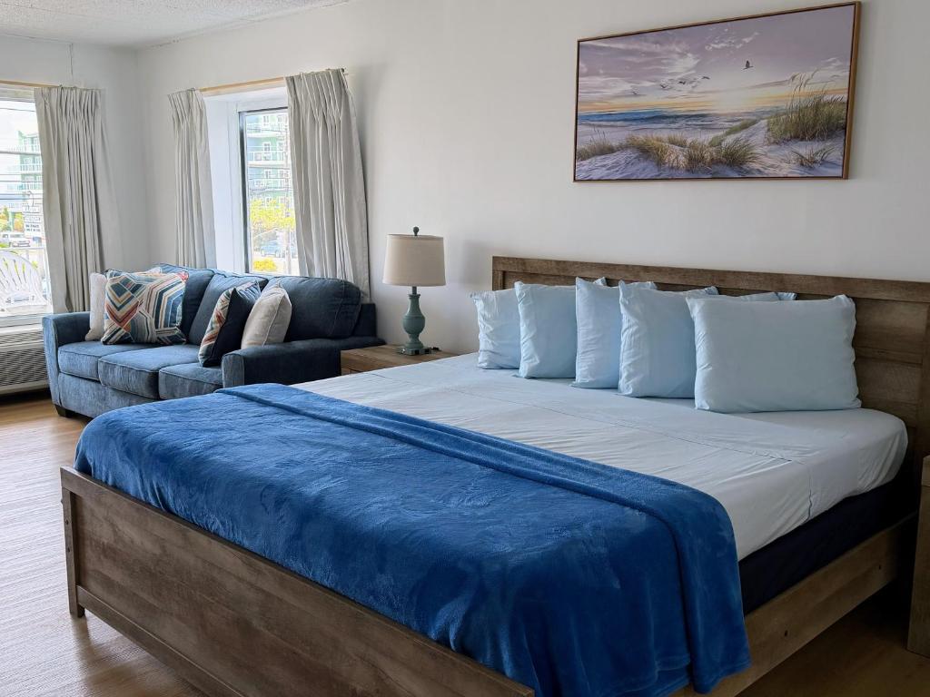 a bedroom with a large bed and a couch at Beachcomber Motel in Ocean City