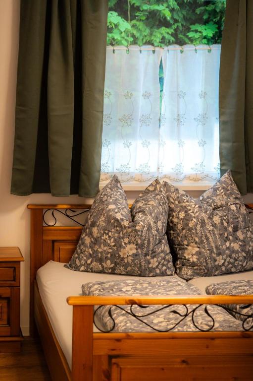 a bed with pillows sitting in front of a window at Ferienwohnung Zur Winkelgasse in Bad Langensalza