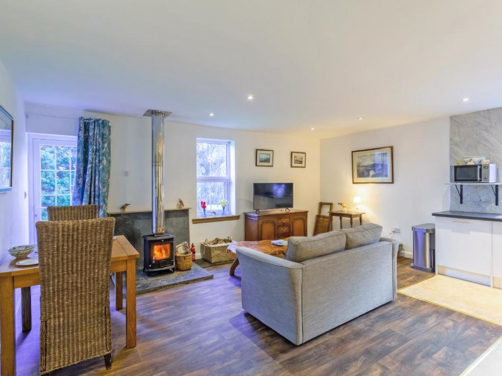 a living room with a couch and a fireplace at The Bungalow in Dingwall