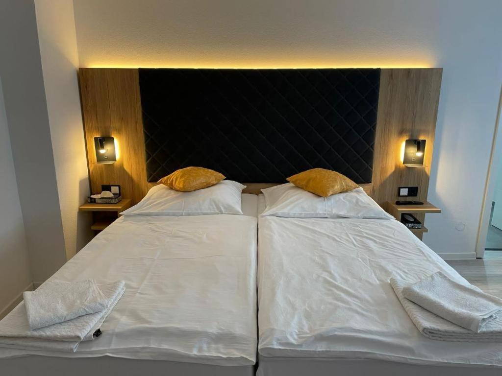 a large bed with two white pillows on it at Hotel & Restaurant Bella Italia in Niederfell