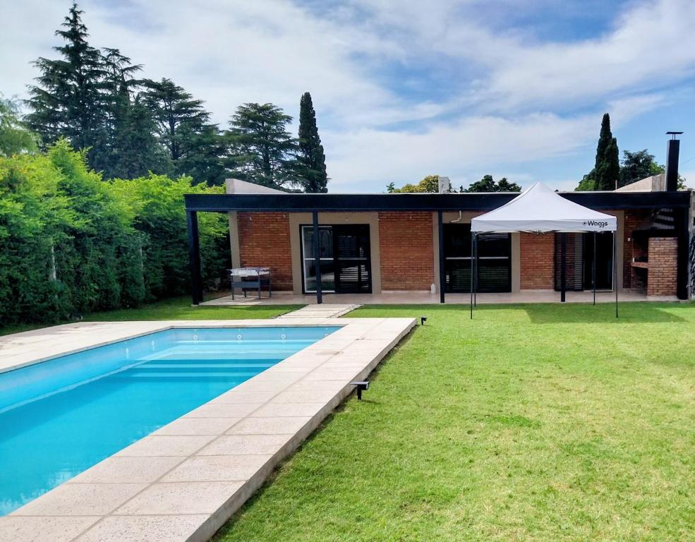 a house with a swimming pool in the yard at Quinta El Encuentro Junín in Junín