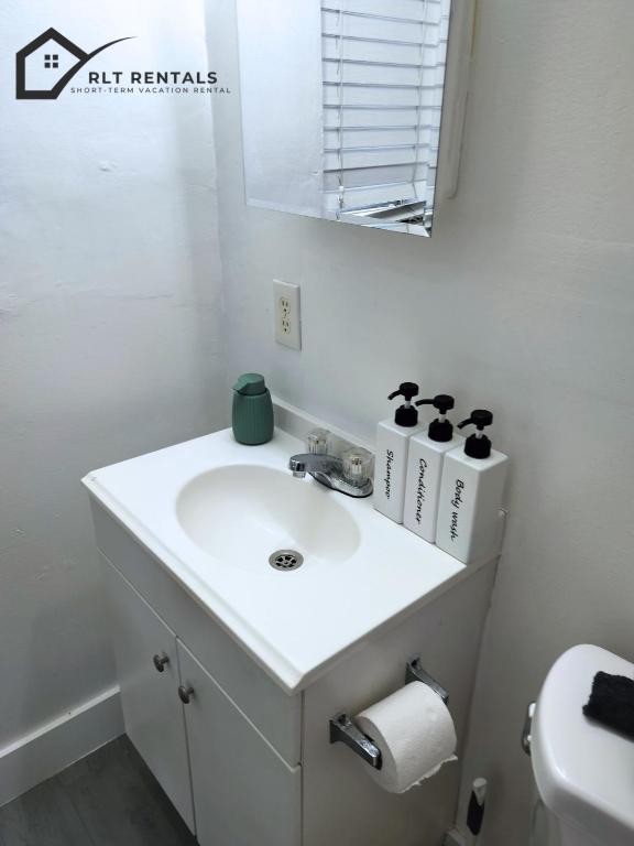 a white bathroom with a sink and a mirror at Cozy studio in Hollywood 101 - 1 in Hollywood