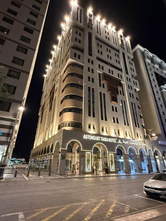 a large white building with lights on top of it at ASTONEAST TAIBA Hotel in Medina