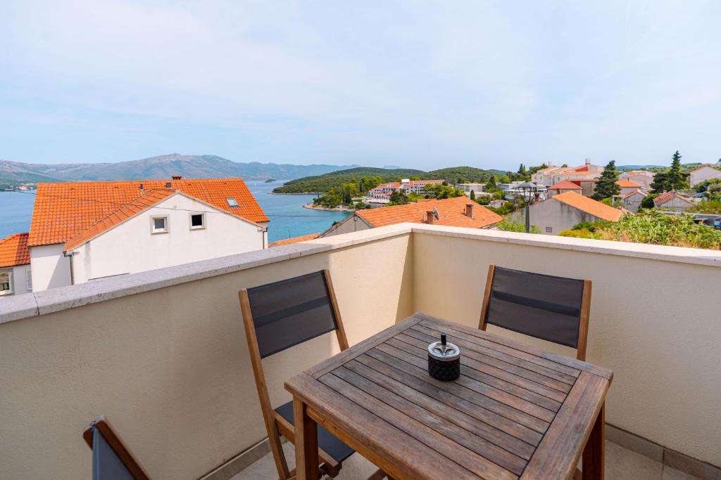 a table and chairs on a balcony with a view at Bella Vita in Korčula