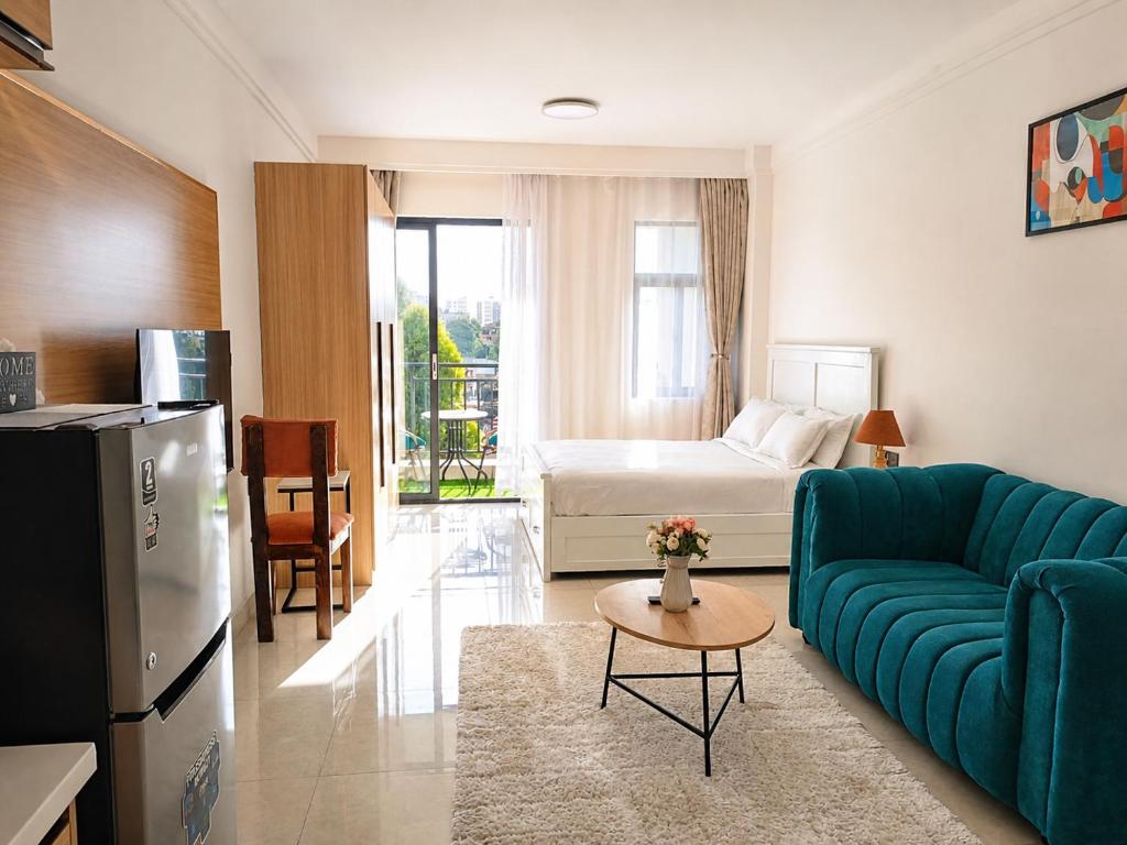 a living room with a couch and a bed at Casa Liora Studio by UN & Two Rivers in Nairobi