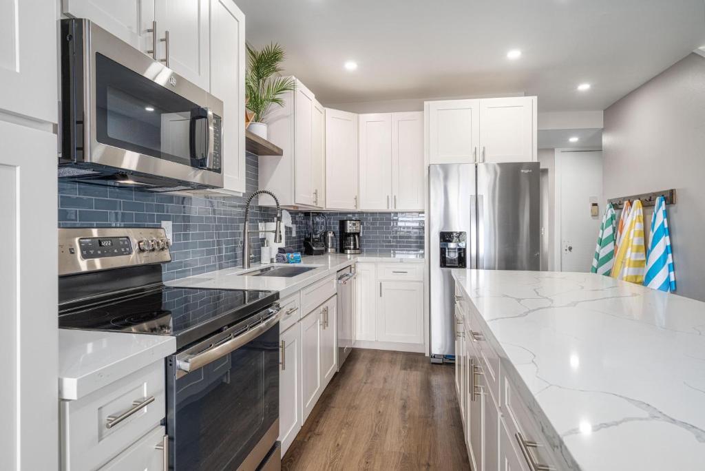 a kitchen with white cabinets and a counter top at 257 Hale Kamaole in Wailea