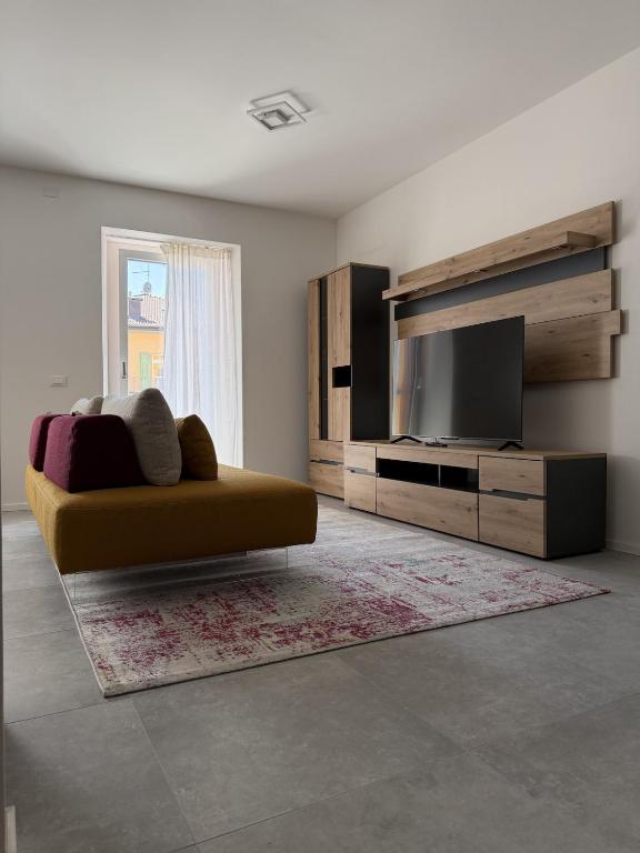 a living room with a couch and a flat screen tv at Z&N Apartment in Levico Terme