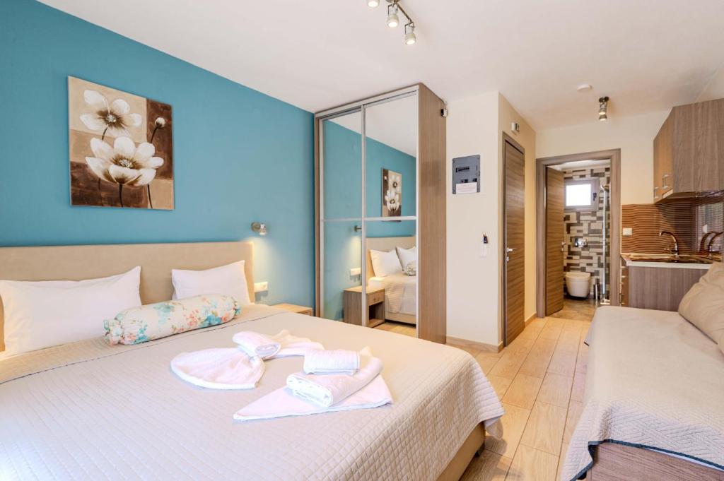 a bedroom with a bed with two towels on it at Studios Sotiria in Limenas