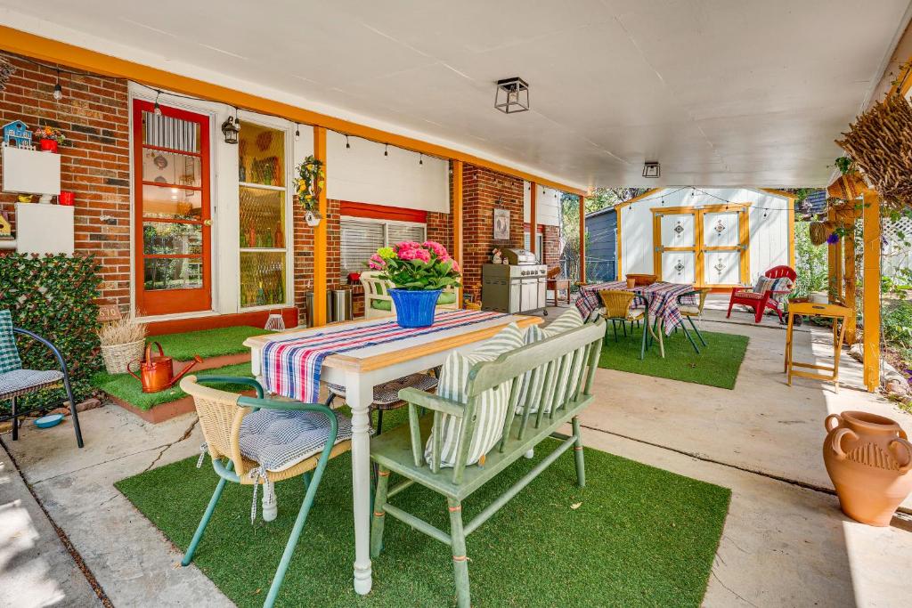 a patio with a table and chairs on a yard at Eclectic Multi-Level Charmer! 2 Mi to CU Boulder in Boulder