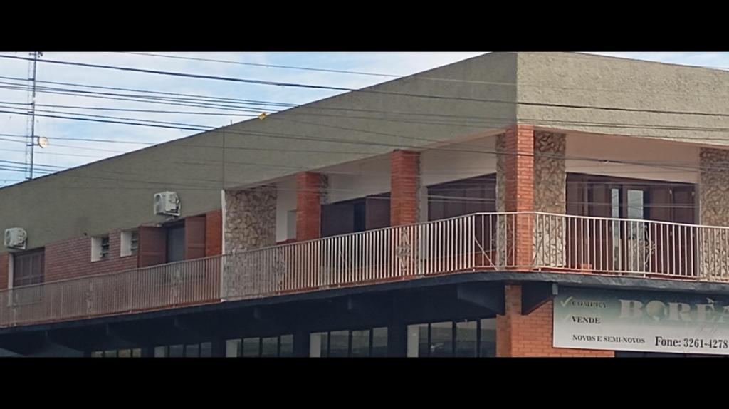 a building with a balcony on the side of it at Pousada da Lú in Jaguarão
