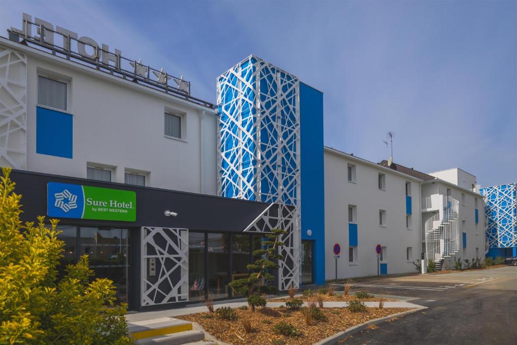 an office building with a blue and white building at Sure Hotel by Best Western Nantes Saint-Herblain in Saint-Herblain