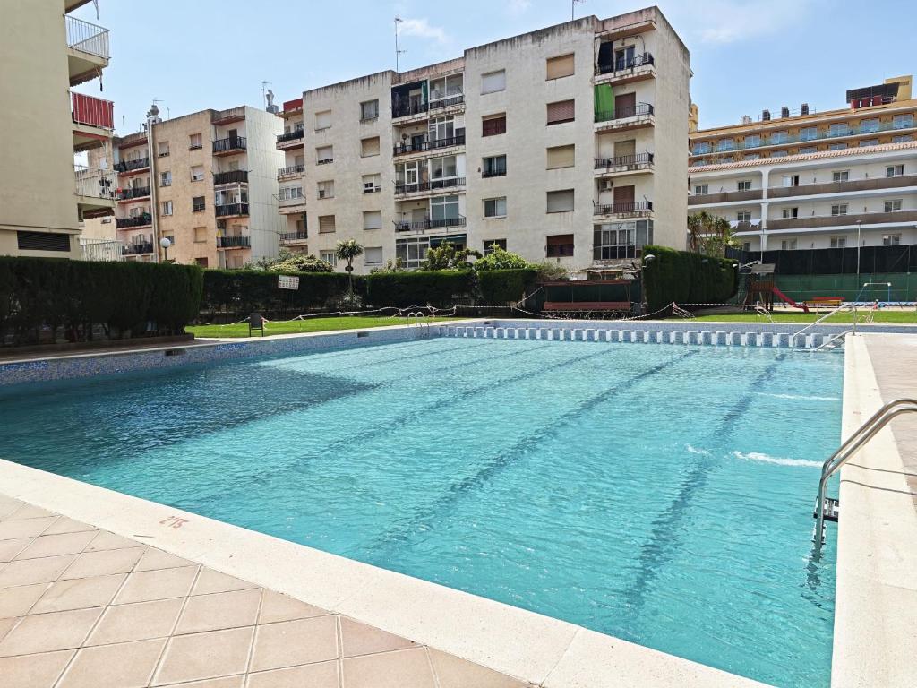a large swimming pool in a city with buildings at Sea&Kids in Malgrat de Mar