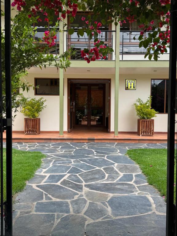 a stone walkway in front of a building at Hotel Sol Natura in Ollantaytambo
