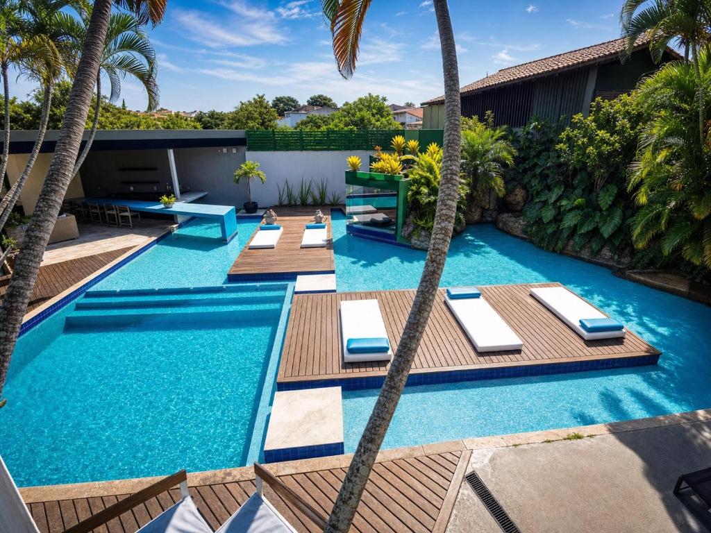 an image of a swimming pool with palm trees at Armação dos Búzios Pousada Design in Búzios