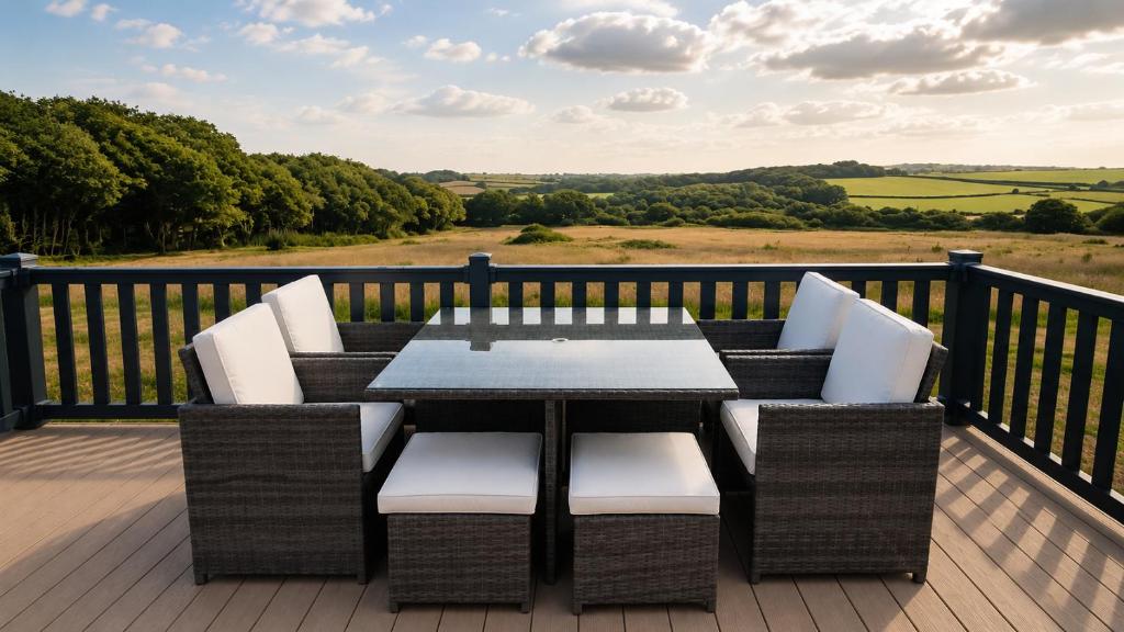 a patio with a table and chairs on a deck at 14B Medina Rise Ferry Offers Available in Porchfield