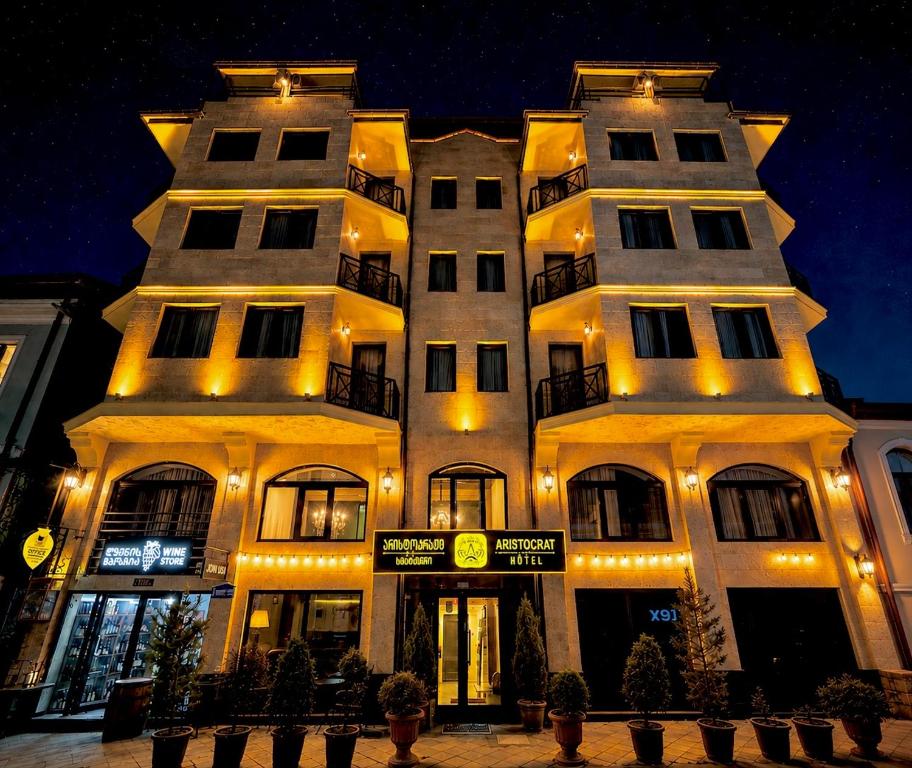 a large white building with lights on it at Hotel Aristocrat Batumi in Batumi
