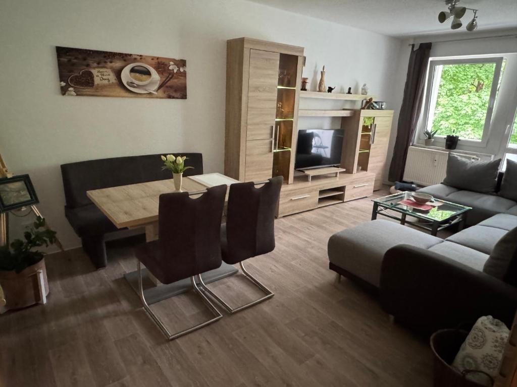 a living room with a couch and a table at Fewo Am Poetenteich in Jänkendorf