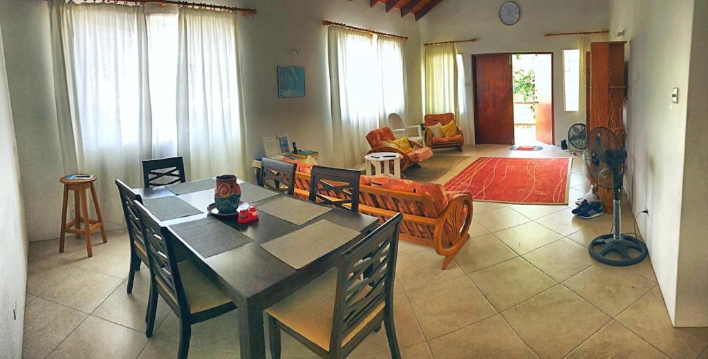 a living room with a table and chairs in it at Claraville Apartment - Unit 2 in Saint James